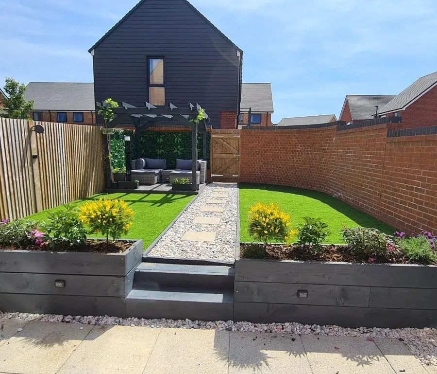 Modern garden with raised planters and a paved path